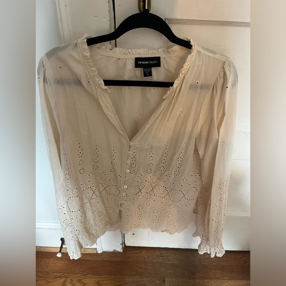 Cream and eyelet shirt.